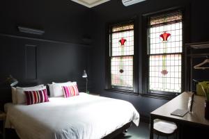 a bedroom with a bed and a window at The Franklin Boutique Hotel in Adelaide