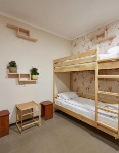 a bedroom with two bunk beds and a table at Hostel Sich in Bukovel