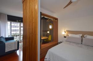 a bedroom with a bed and a chair and a table at SUITE DE LUJO-CENTRO Kilometro 0-PARKING in Vigo
