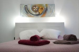 a bedroom with a bed with pillows and a painting at Apartment Sagrera in Barcelona