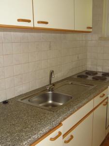 a kitchen with a sink and a stove at Apartments Kleinseeblick in Sankt Kanzian +77 photos