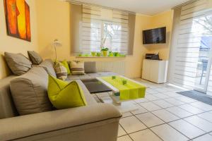 a living room with a couch and a table at Ferienwohnung Behner in Greven