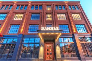 a red brick building with a sign on it at The Ramble Hotel in Denver