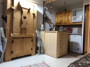 a kitchen with wooden cabinets and a counter top at Résidence "Rado" in Samoëns