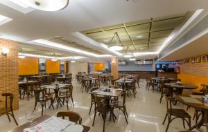 a restaurant with tables and chairs in a room at Space Residence in Manaus