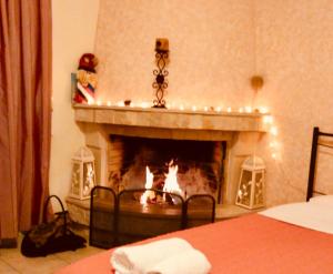 a living room with a fireplace with christmas lights at Filoxenia in Choudetsi