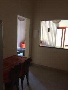 a bedroom with a bed and a large window at Privacidade e Conforto no Saco da Capela in Ilhabela