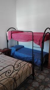 a bedroom with a bunk bed with a red and blue blanket at Un mare da sogno in Sannicola