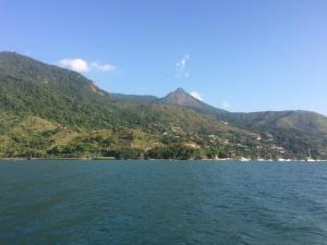 a large body of water with mountains in the background at Privacidade e Conforto no Saco da Capela in Ilhabela