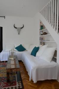 two beds in a living room with a staircase at Villa Trumpetaren in Visby +28 photos