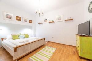 a bedroom with a bed and a flat screen tv at BonTon Apartments Sibiu in Sibiu
