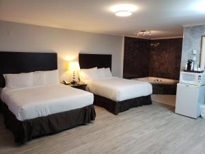 Voodi või voodid majutusasutuse Regency Inn & Suites toas