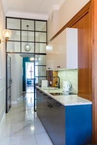 a kitchen with a blue and white counter top at MR 3 Apartments in Kraków