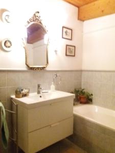 a bathroom with a sink and a tub and a mirror at "LA MAISON DEL CORSO" Hospitality in Pisa +41 photos