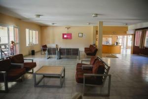 a lobby with couches and chairs and a table at Convivir Departamentos in Córdoba