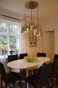 a dining room with a white table and chairs at Villa Trumpetaren in Visby