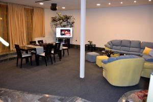 a living room with a couch and a dining room at Persey Villa Borovets in Borovets