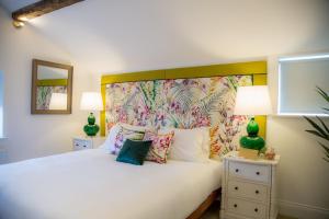 um quarto com uma cama branca e uma cabeceira colorida em Winckley Stays em Preston