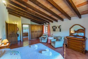 a bedroom with a large bed and a mirror at Villa El Olivo in Pollença +29 photos