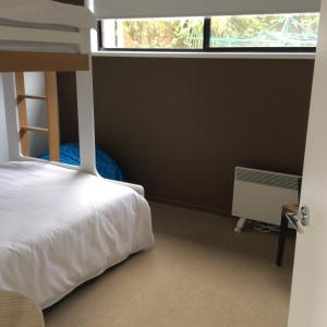 a bedroom with a bunk bed and a window at Pacific Paradise in Torquay