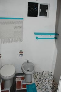 a bathroom with a toilet and a sink at La Escondida in Punta del Este