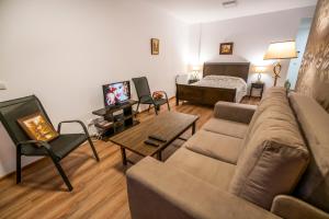 a living room with a couch and a bed at Ripsime Colina Marei in Sinaia