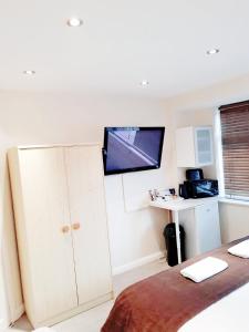 a bedroom with a flat screen tv on the wall at The 22 in London