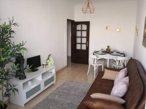 a living room with a couch and a table at Graça Lovers 2 in Lisbon