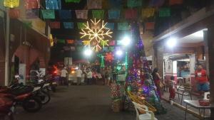 a group of people walking around a market with christmas decorations at Casa Arcoiris Zihuatanejo B&B in Zihuatanejo