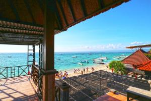 a view of a beach with boats in the water at The Beach Huts Lembongan in Nusa Lembongan