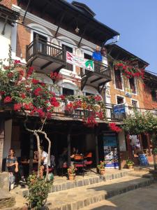 a building with a balcony with flowers on it at Bandipur chhen in Bandīpur