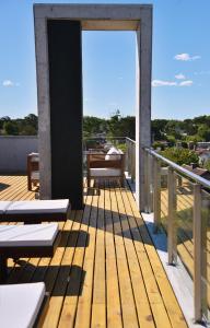 a wooden deck with benches on a roof at El viejo jardin in Villa Gesell
