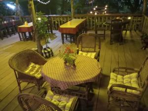 a table and chairs on the deck of a restaurant at Xuanmai Garden Resort in Pakse
