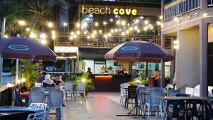 a restaurant with chairs and tables and umbrellas at Best Star Resort in Pantai Cenang
