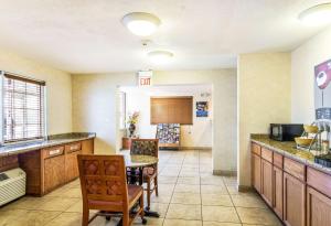 a large kitchen with a table and chairs at Motel 6-Alsip, IL in Alsip