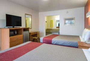 a hotel room with two beds and a flat screen tv at Motel 6-Concord, CA in Concord