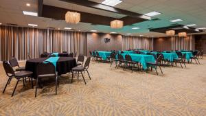 a banquet hall with blue tables and chairs at Best Western Plus Landing View Inn & Suites in Branson