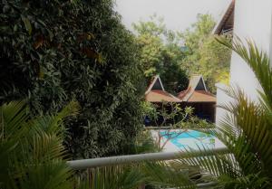 a hedge around a swimming pool in a resort at iRoHa Garden Hotel & Resort in Phnom Penh