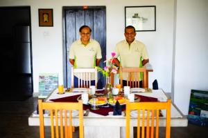 two men standing in front of a table at Waters Edge, Anuradhapura in Anuradhapura