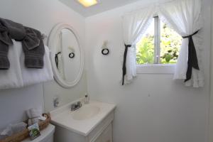 a bathroom with a sink, mirror, and toilet at Seagull Inn Bed & Breakfast in Mendocino