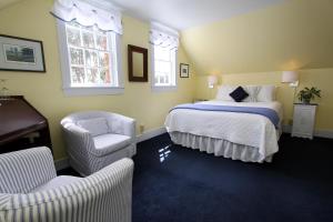 a hotel room with a bed and a chair at Seagull Inn Bed & Breakfast in Mendocino