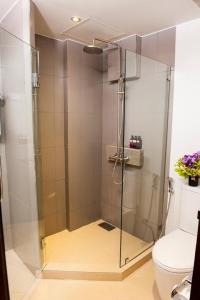 a shower stall in a bathroom with a toilet at Montien House - SHA Plus in Chaweng +36 photos
