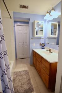 a bathroom with a sink and a mirror and a shower at Modern Montrose Condo in Houston