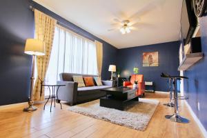 a living room with a couch and a table at Modern Montrose Condo in Houston