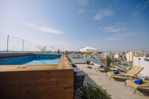 a swimming pool on the roof of a building at Qbic City Hotel in Larnaka