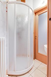 a shower with a glass door in a bathroom at Studio Mazzini in Forlì