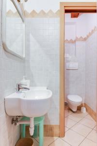 a bathroom with a sink and a toilet at Studio Mazzini in Forlì