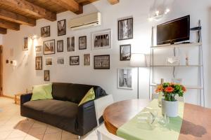 a living room with a couch and a table at Studio Mazzini in Forlì