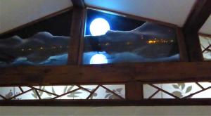 a view of the moon through a window at Guest House Smoothy in Fukuyama