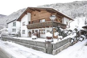 a large wooden house with snow on it at Haus Lutt in Ried im Oberinntal